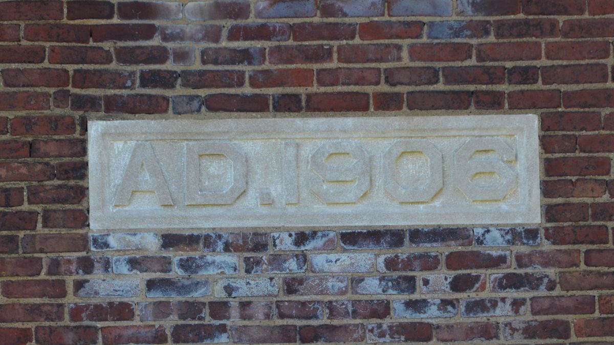 Cornerstone reading A.D. 1906 on the former administration building